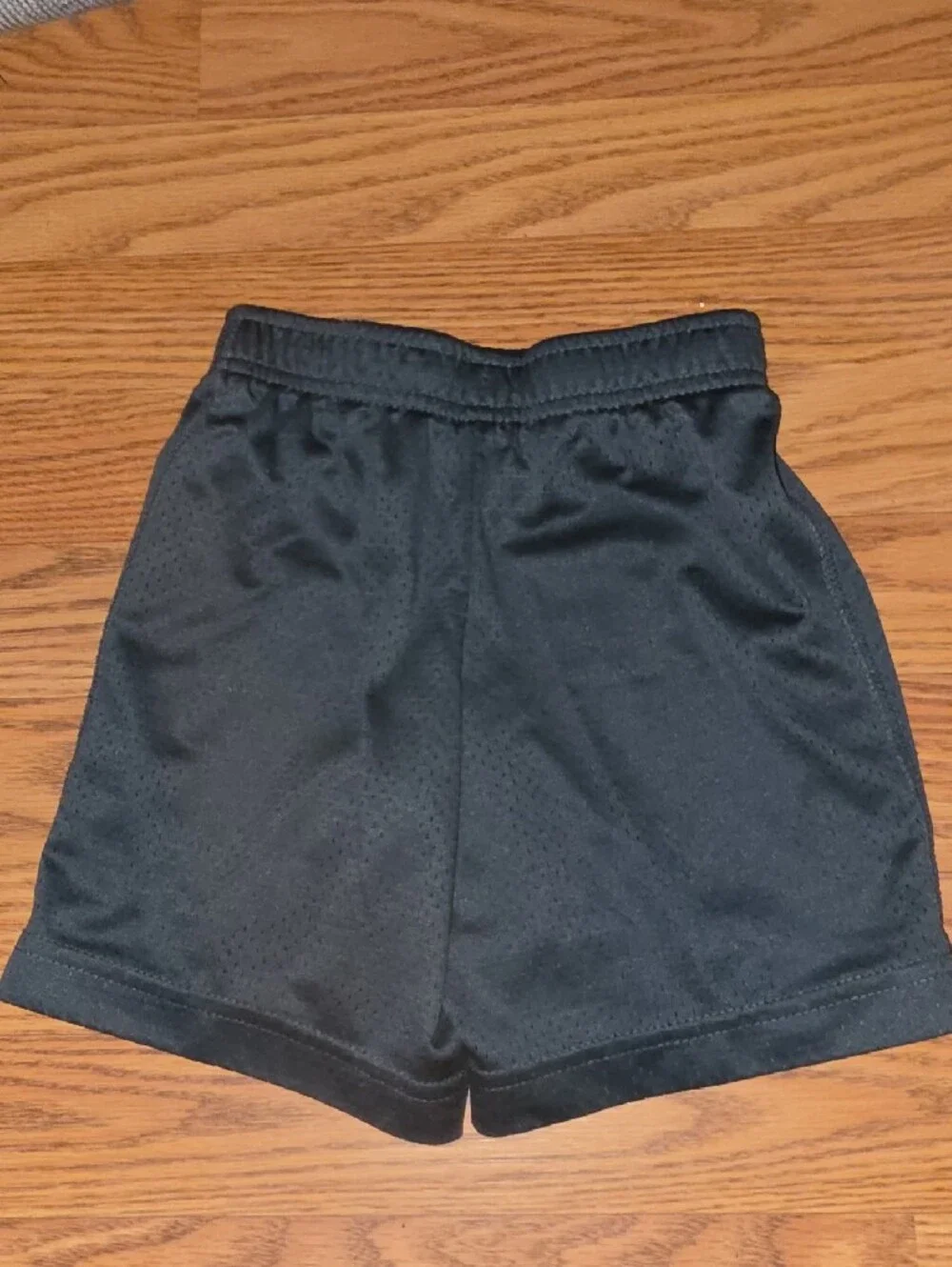 Nike Black Mesh Kids Athletic Shorts with White Swoosh